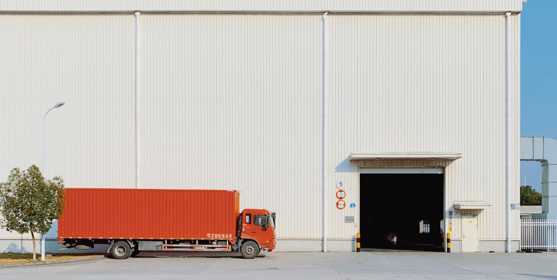 A truck is standing next to the factory